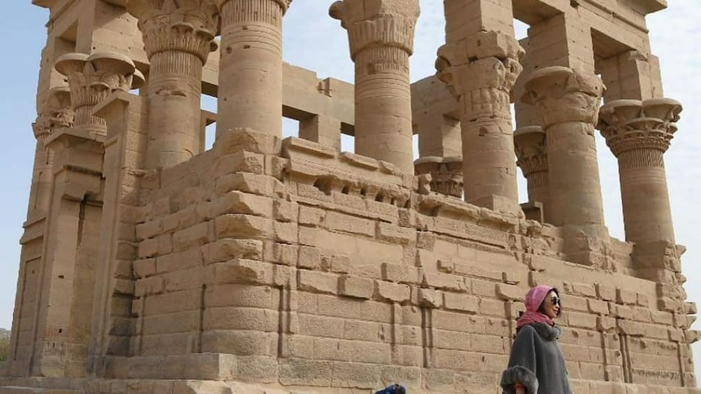 Woman poses in front of Trajan's Kiosk in Aswan, Egypt 