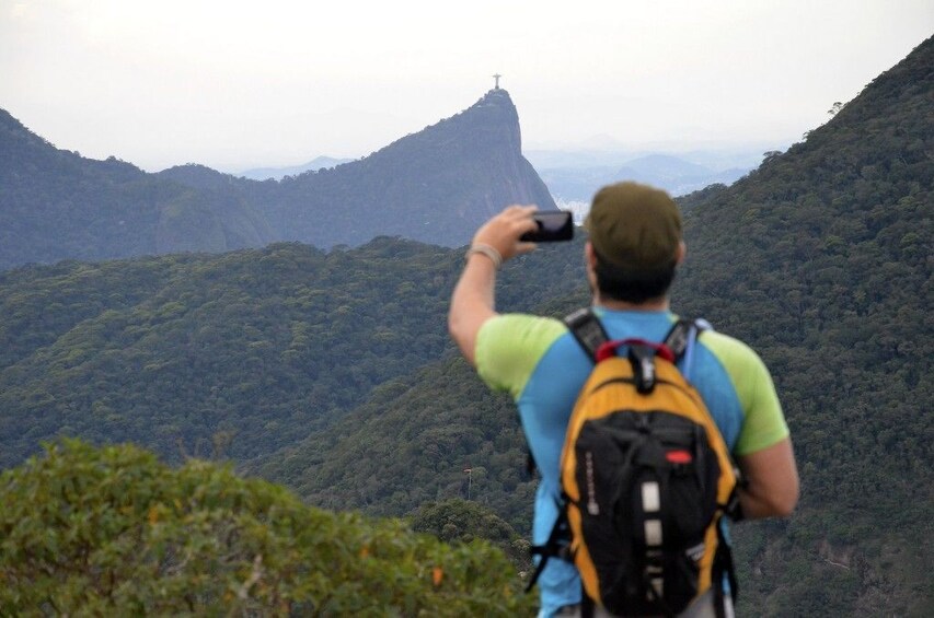 Man taking a photo of the view from Pedra Bonita