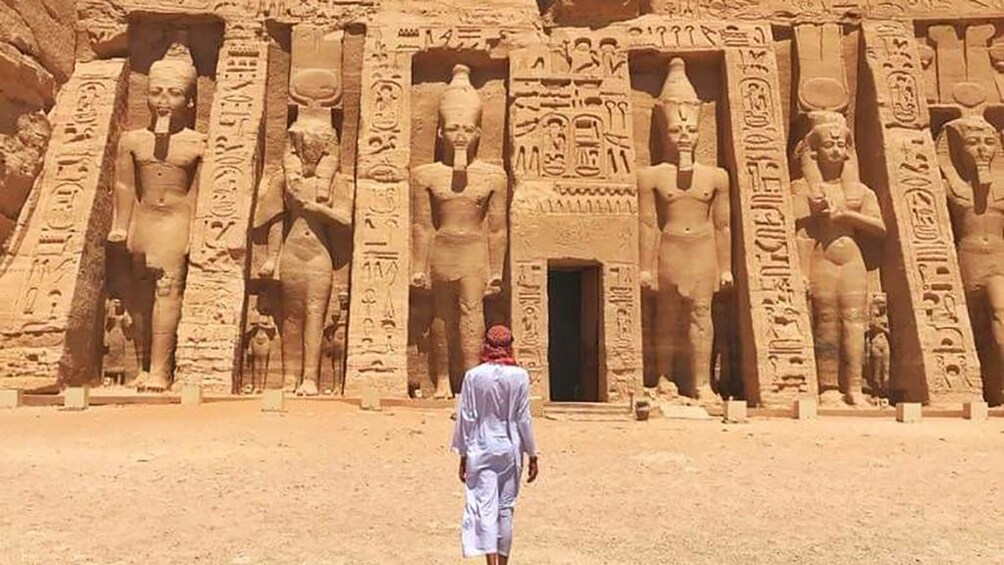 Person walks towards Abu Simbel Temples in Aswan, Egypt