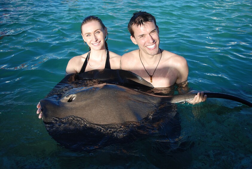 Couple encountering a sting ray in Punta Cana 