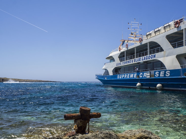 Blue waters of Comino Island with cruise ship to the side