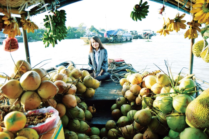 Local woman selling fruit from a boat in Vietnam 