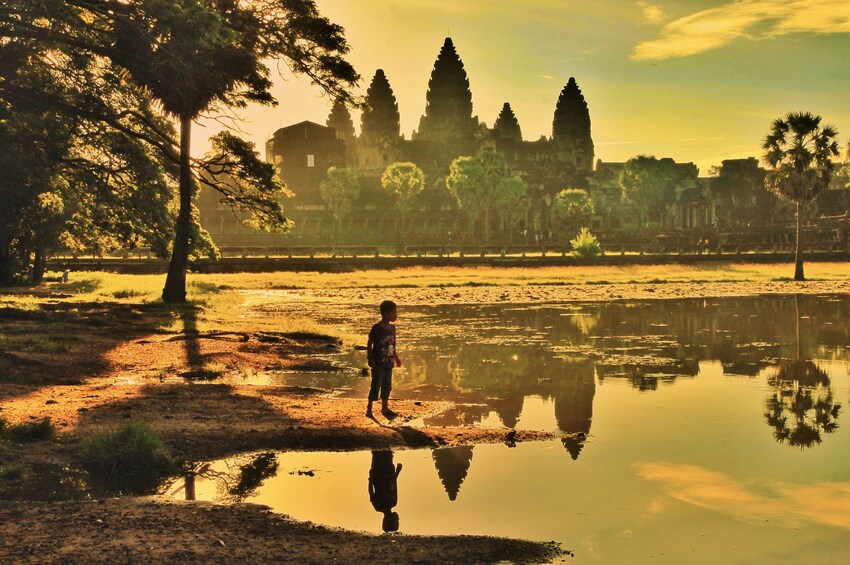 Child admiring the sunset over Angkor Wat Temple in Siem Reap, Cambodia