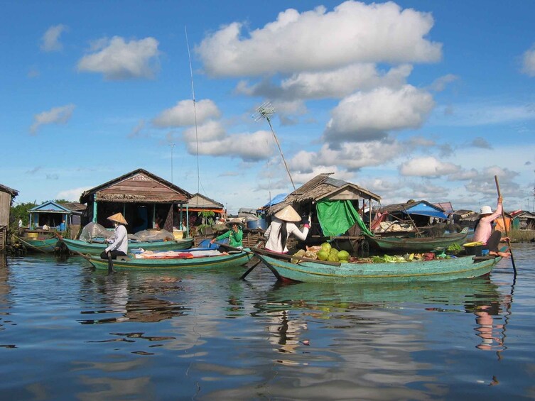 Vendors row boats full of fruit across Tonle Sap Lake in Cambodia