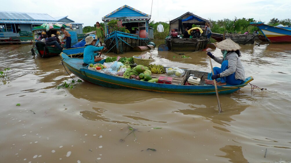 Vendors with boats full of fruit on Tonle Sap Lake in Cambodia