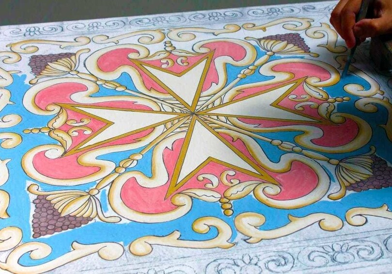 Closeup of person painting medallion at Search Results Ta' Qali Crafts Village in Malta
