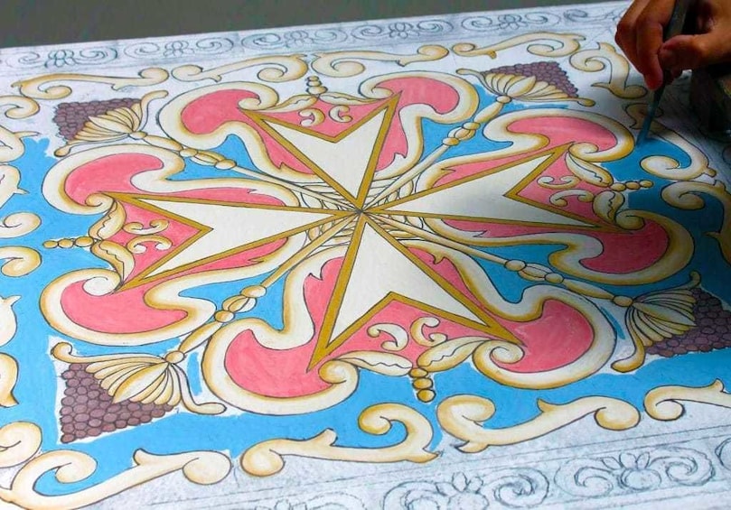 Closeup of person painting medallion at Search Results Ta' Qali Crafts Village in Malta