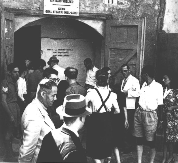 Black and white photo of people entering the air raid shelter
