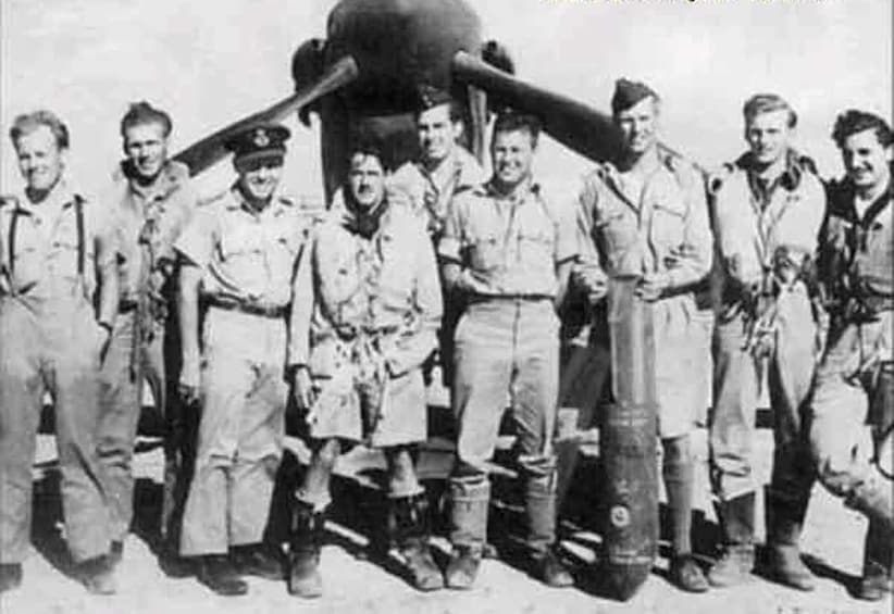 Soldiers pose in front of plane in Malta