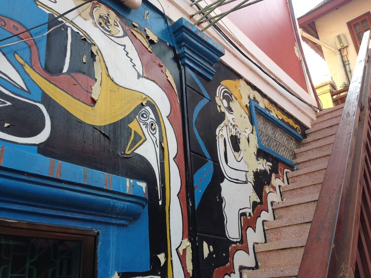 Pop art-style murals along stairwell in Cambodia