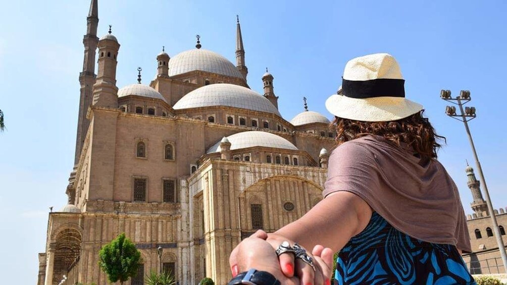 Woman leads partner towards the Mosque of Muhammad Ali in Cairo, Egypt