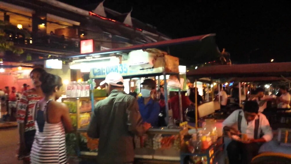 People order food at a stall at Siem Reap street market