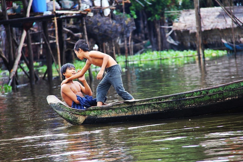 Local boys on a boat in Kampong Phluk