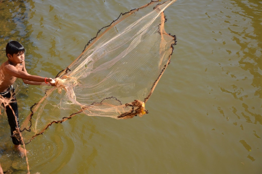 Local man fishing in the Kompong Khleang Floating Village in Siem Reap