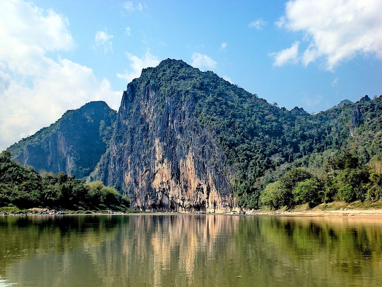 Nam Ou River surrounded by jungle-covered mountains