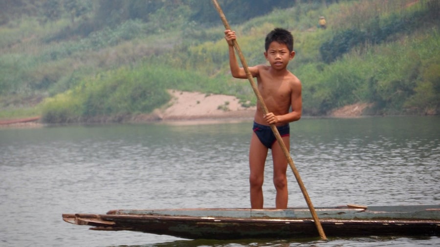 Young boy on a raft on the Nam Ou River