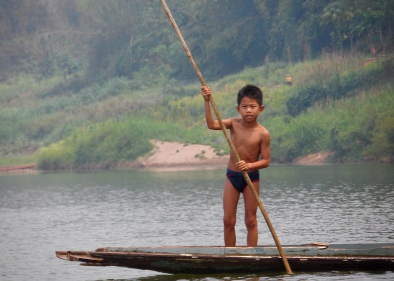 Young boy on a raft on the Nam Ou River