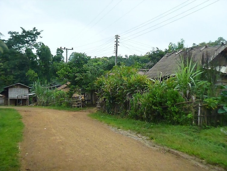 Dirt road line with homes in Khmu Village