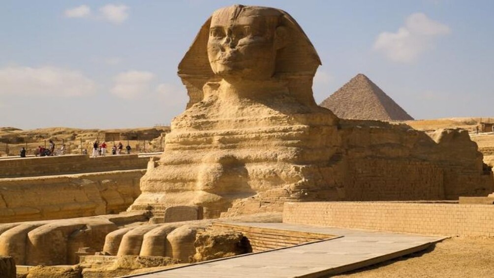 The Sphinx of Giza with a pyramid in the background