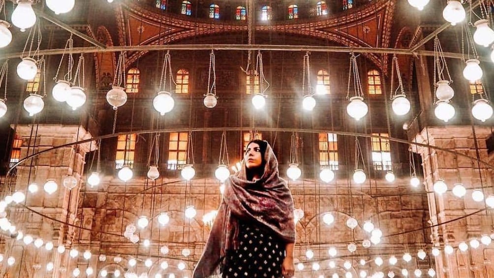 Woman in headscarf poses inside the Mosque of Muhammad Ali