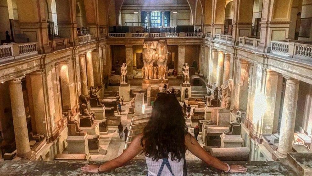 Woman looks over balcony at Egyptian Museum