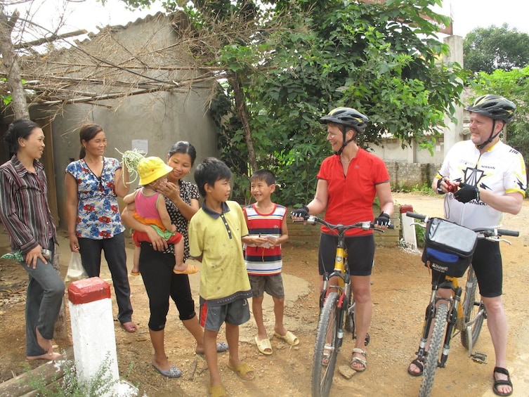 Bikers talk to locals in rural Luang Prabang, Laos