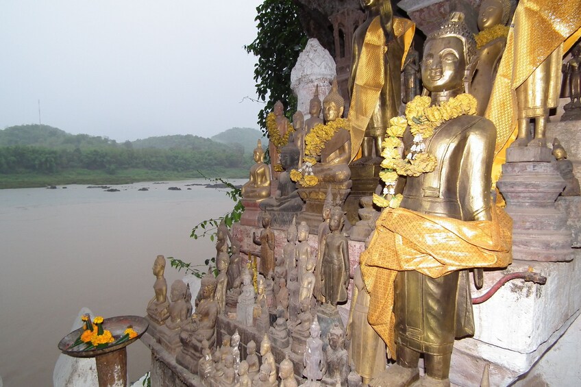 Closeup of golden Buddha statues at Pak Ou Caves in Laos