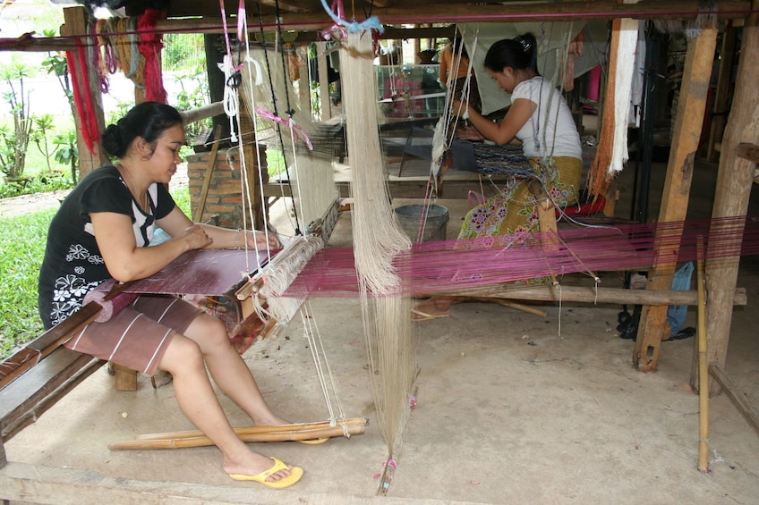 Women weave fabric in Ban Phanom Village in Laos