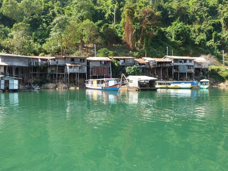 Buildings and boats on the bright blue waters of Nam Ngum River in Laos