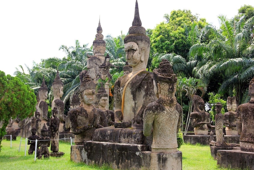 Large Buddha statue with attending Buddhas at Buddha Park in Vientiane, Laos
