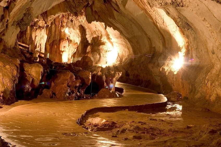 Path along lit interior of Elephant Cave in Vang Vieng, Laos