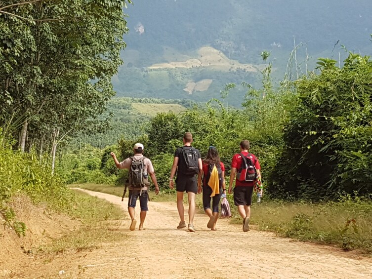 Small group walk along dirt road of Vang Vieng, Laos