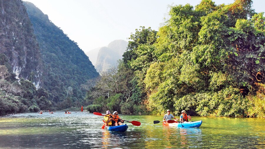 People kayak on Nam Song River in Vang Vieng, Laos