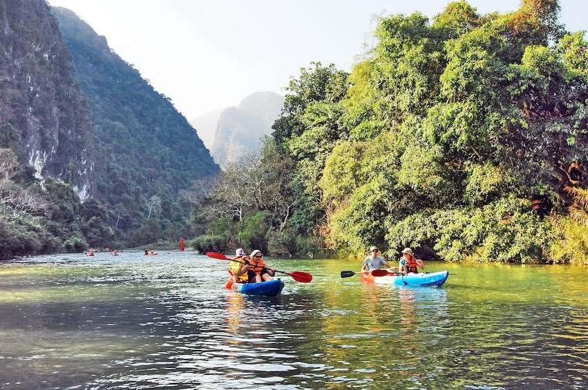 Tourists kayak in Nam Song River in Vang Vieng, Laos