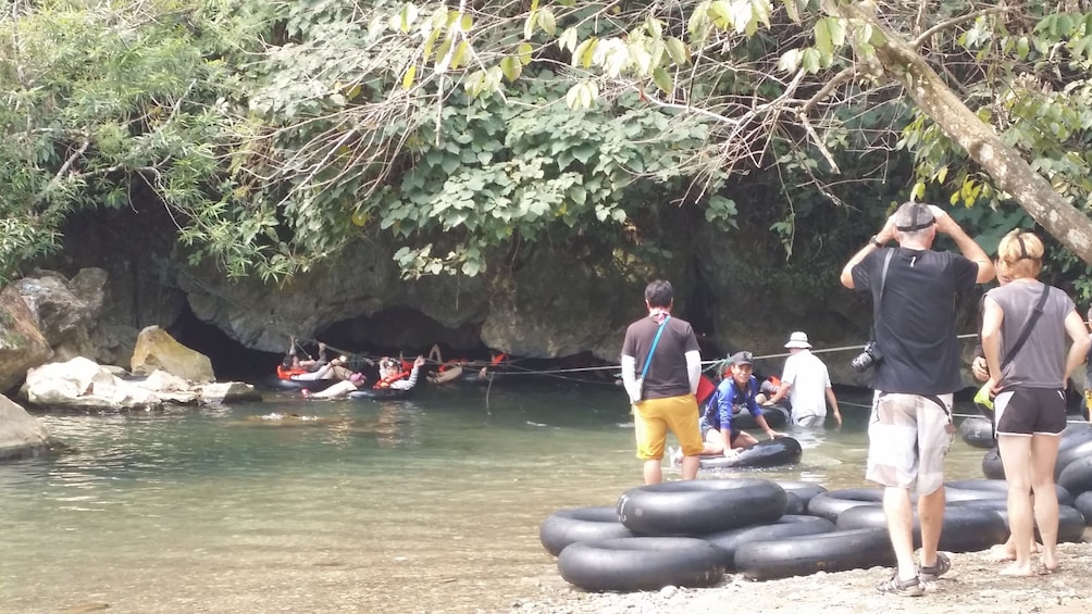 People inner tube into Tham Xang Cave in Vang Vieng, Laos