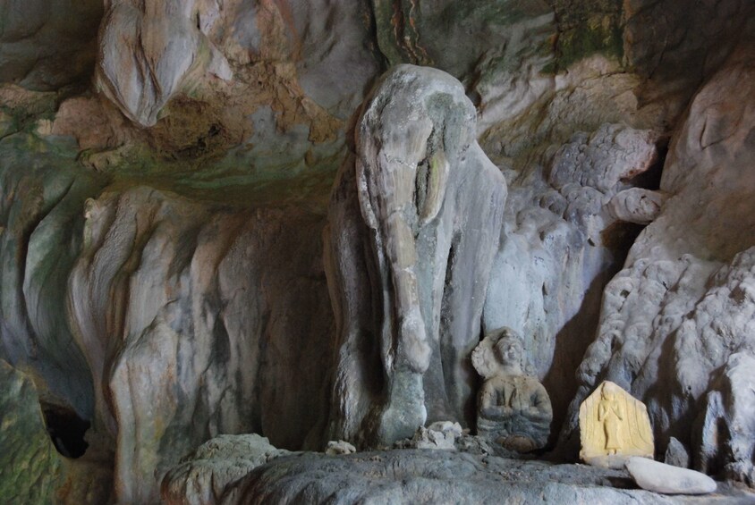 Old elephant and Buddha statues in Tham Xang Cave in Vang Vieng, Laos