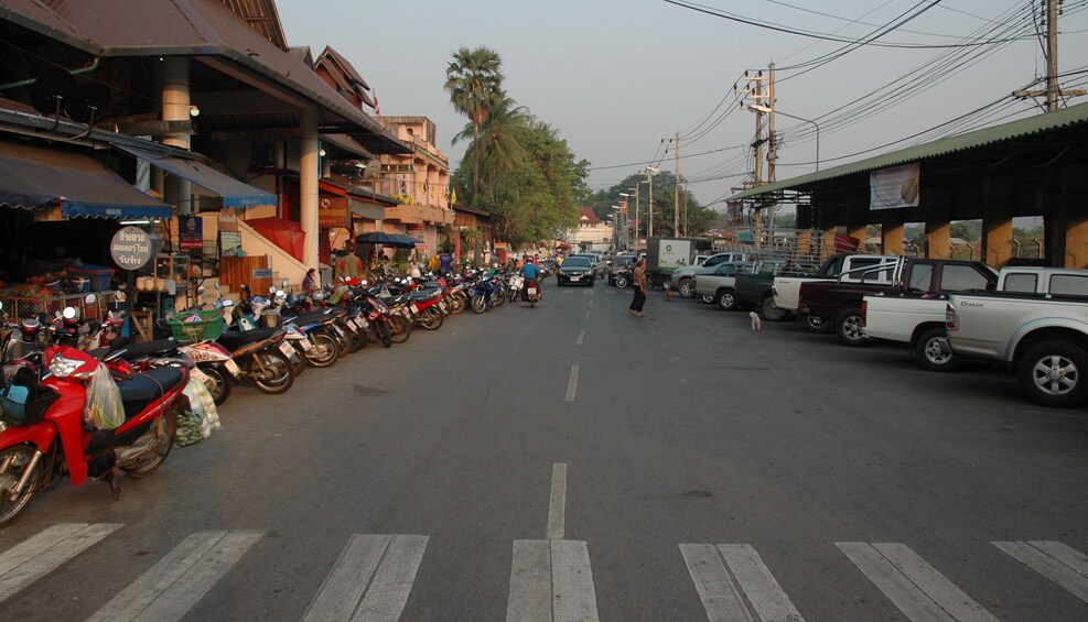 Street full of parked cars and mopeds in Mae Hong Son

