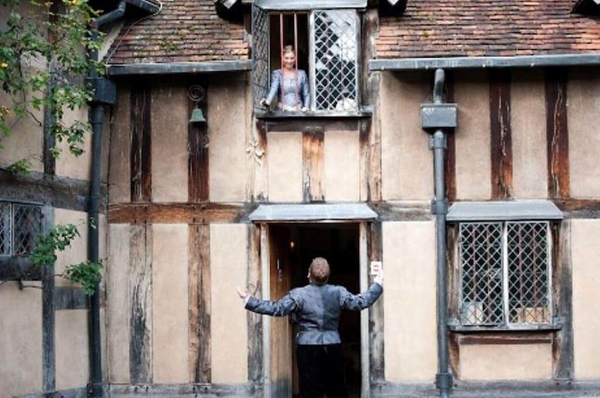 Woman looking down from an open window at Shakespeare’s Stratford