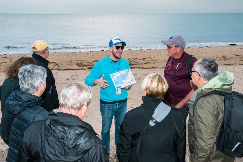 Tour guide with group on the beach at Normandy 