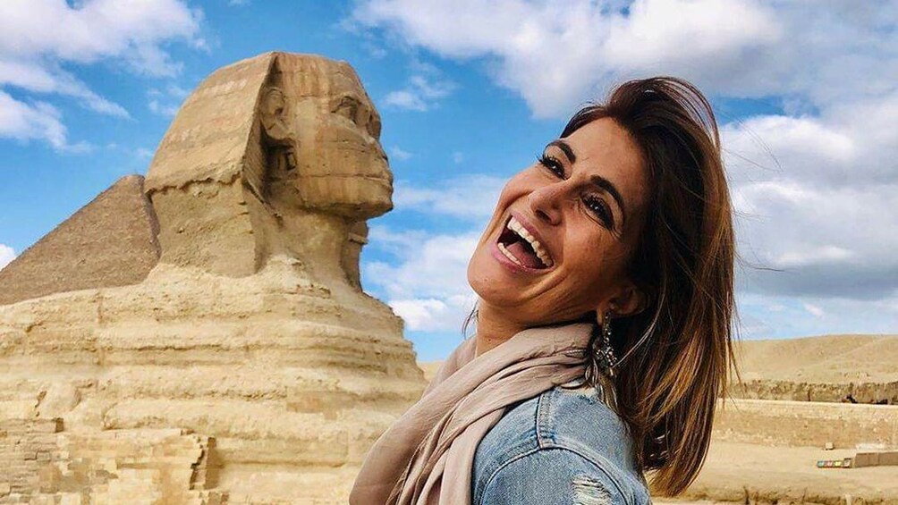 Closeup of woman smiling with Sphinx in the background