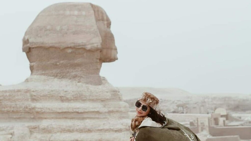 Woman poses in front of Sphinx of Giza