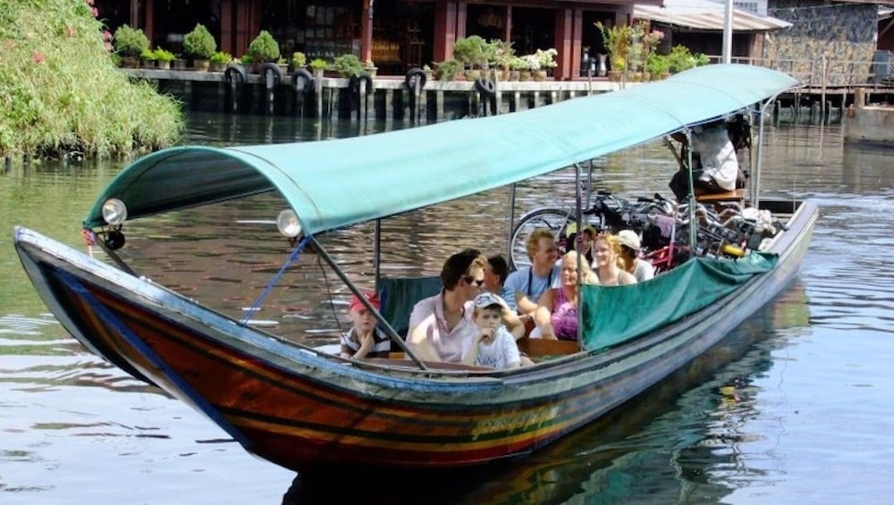 Closeup of long covered boat in Chao Phraya River in Bangkok, Thailand