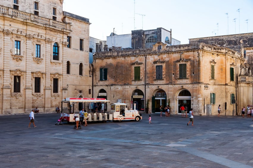 Tour bus in courtyard of Lecce Cathedral