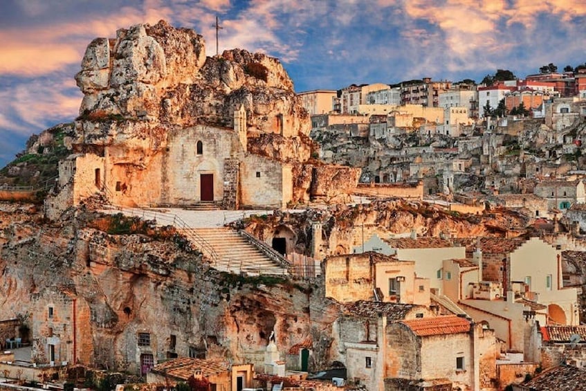 Buildings on the coast of Matera at sunset