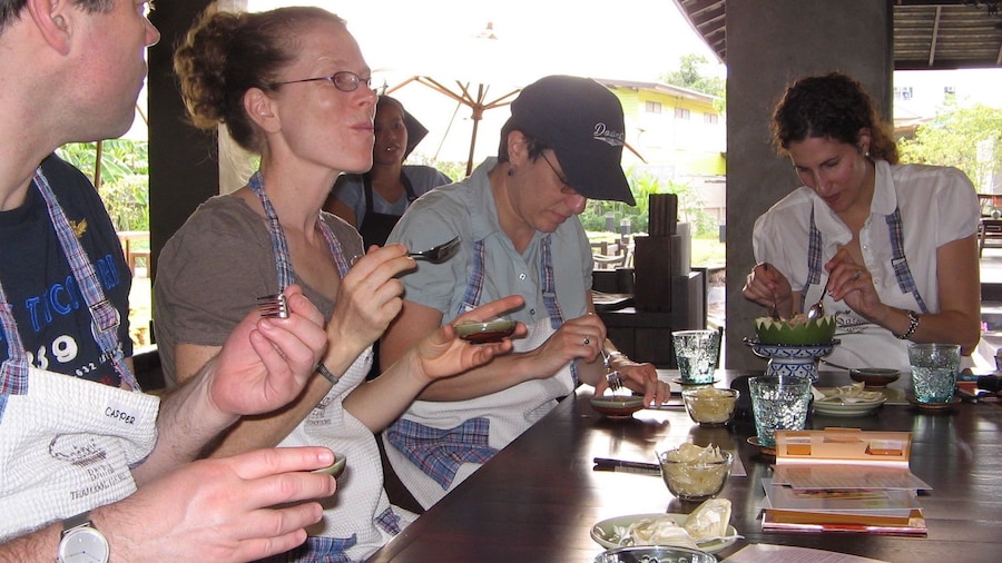 Tourists try appetizer during Thai cooking class