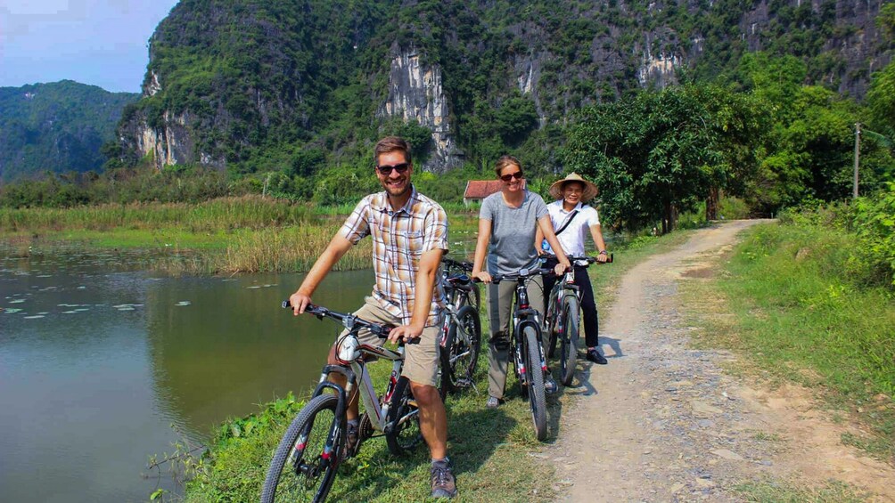 Tourists on bikes pose along Ninh