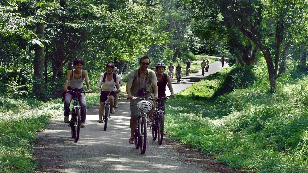 Tourists bike through Cuc Phuong National Park