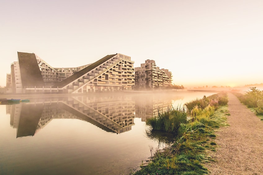 Show item 2 of 7. Waterfront buildings and their reflections and a small path in Copenhagen, Denmark