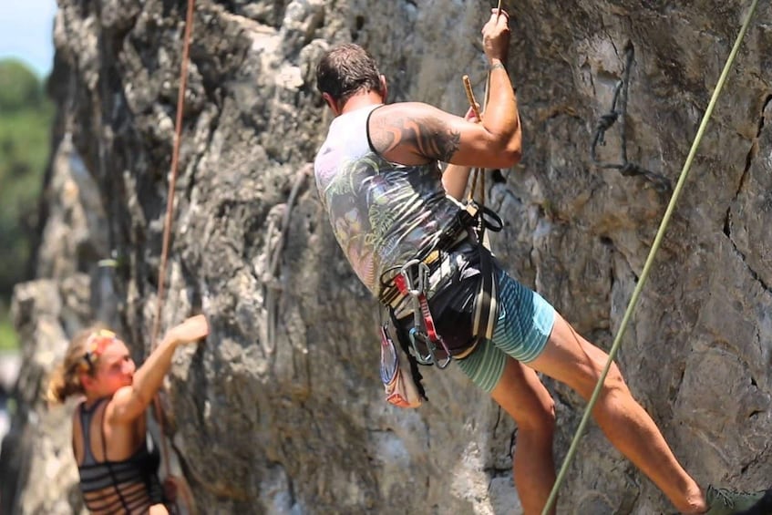 Couple on a rock climbing course at Railay Beach