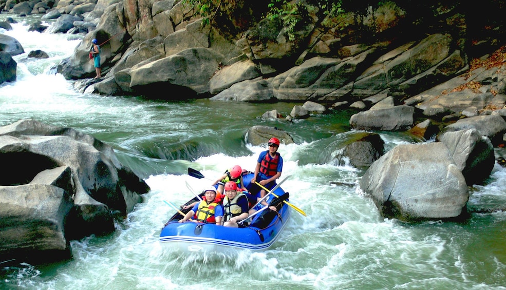 Boat floating down Mae Taeng River on a whitewater rafting adventure 